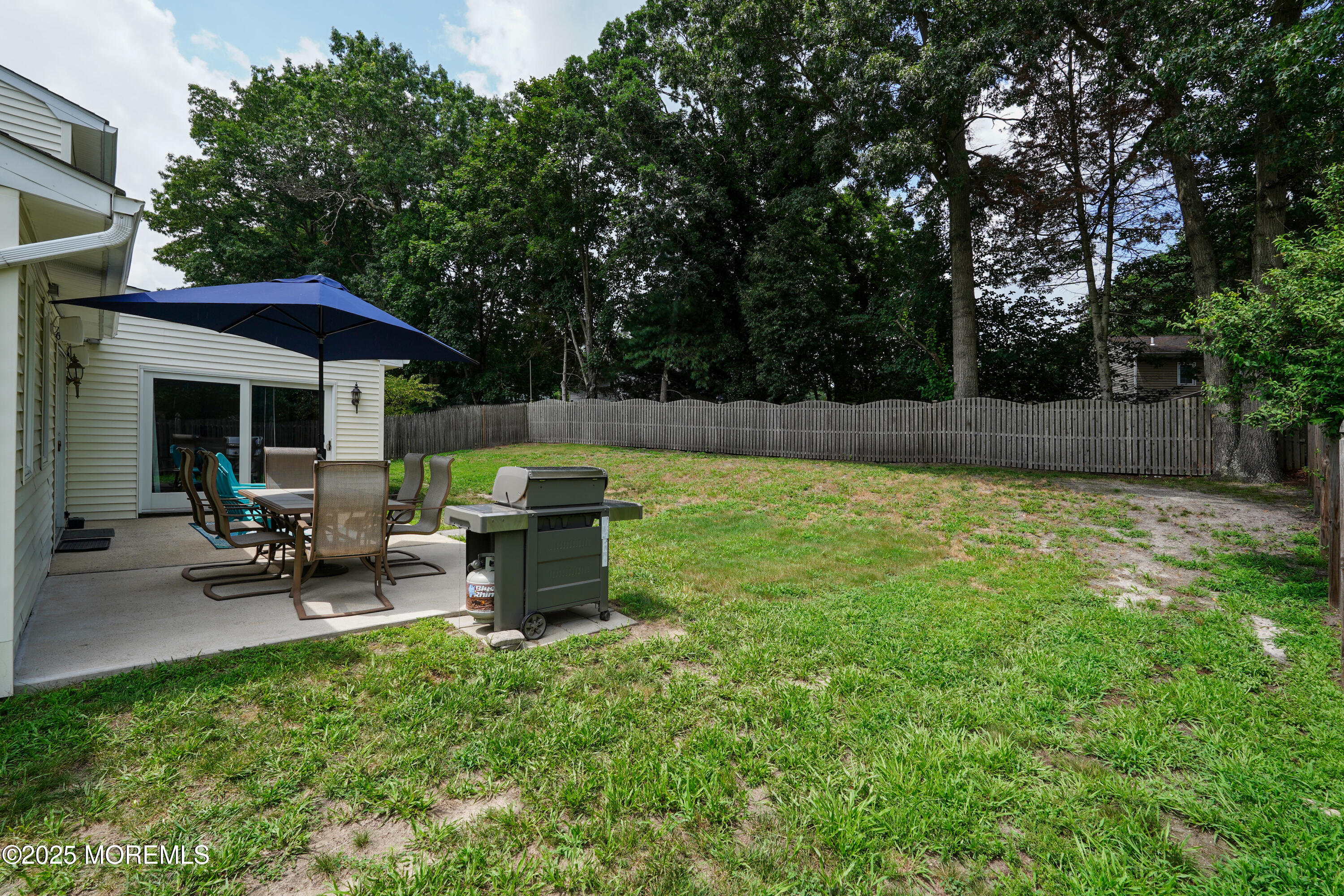 12 Quailtree Lane Howell, NJ 07731 - Photo 45 of 51 a view of a patio with table and chairs under an umbrella