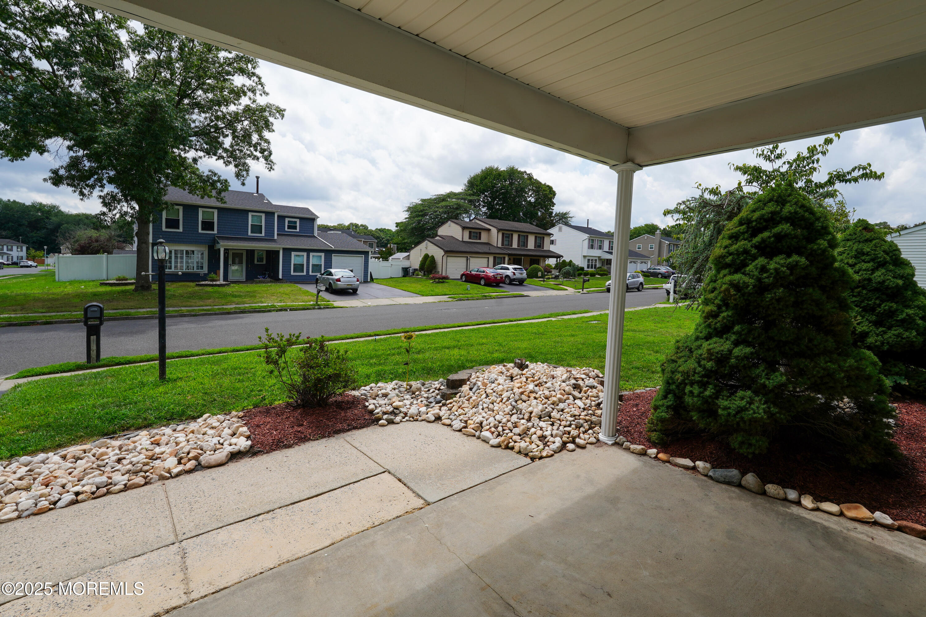 12 Quailtree Lane Howell, NJ 07731 - Photo 50 of 51 a front view of a house with a yard and outdoor seating