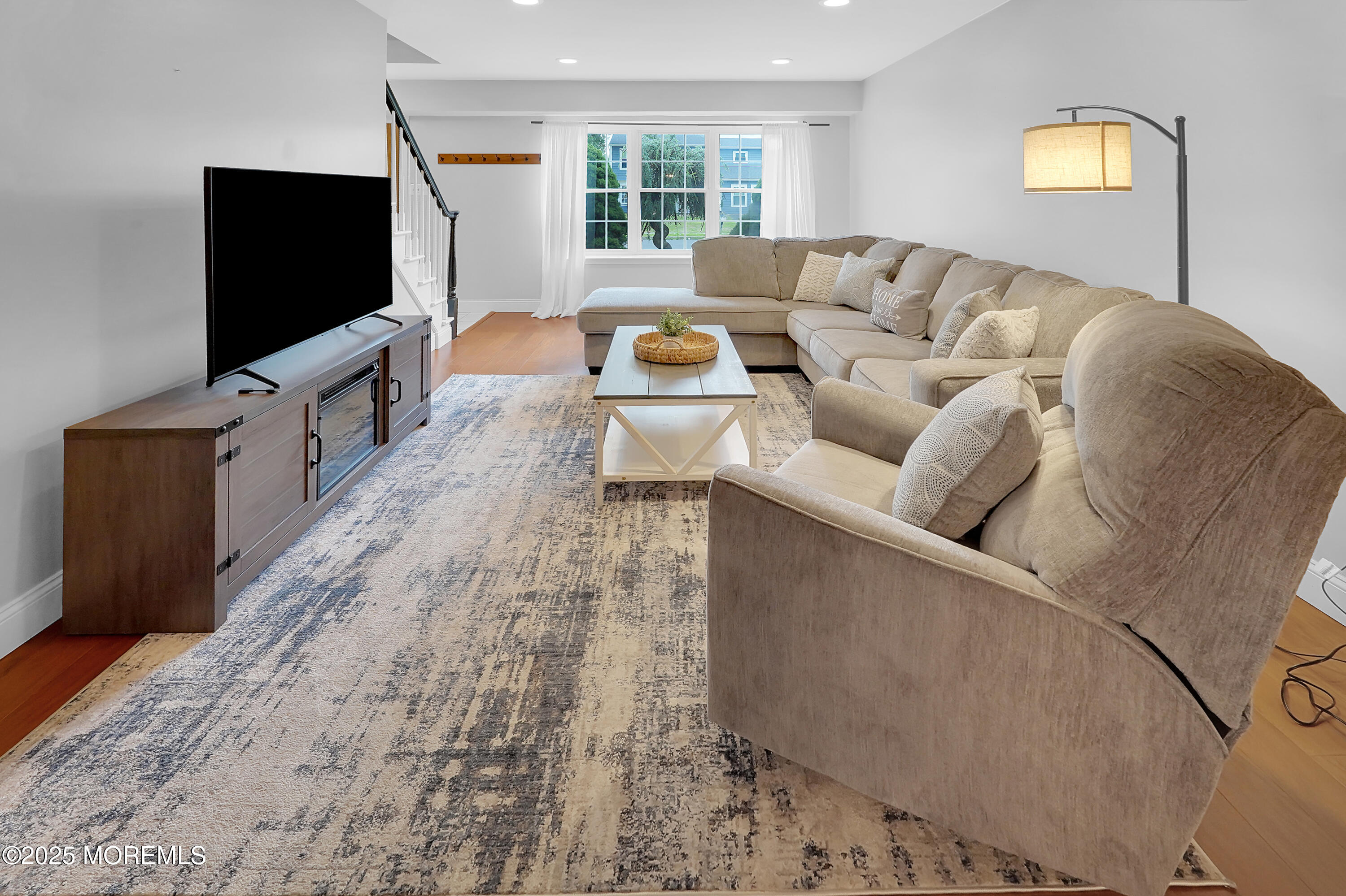 12 Quailtree Lane Howell, NJ 07731 - Photo 8 of 51 a living room with furniture and a flat screen tv