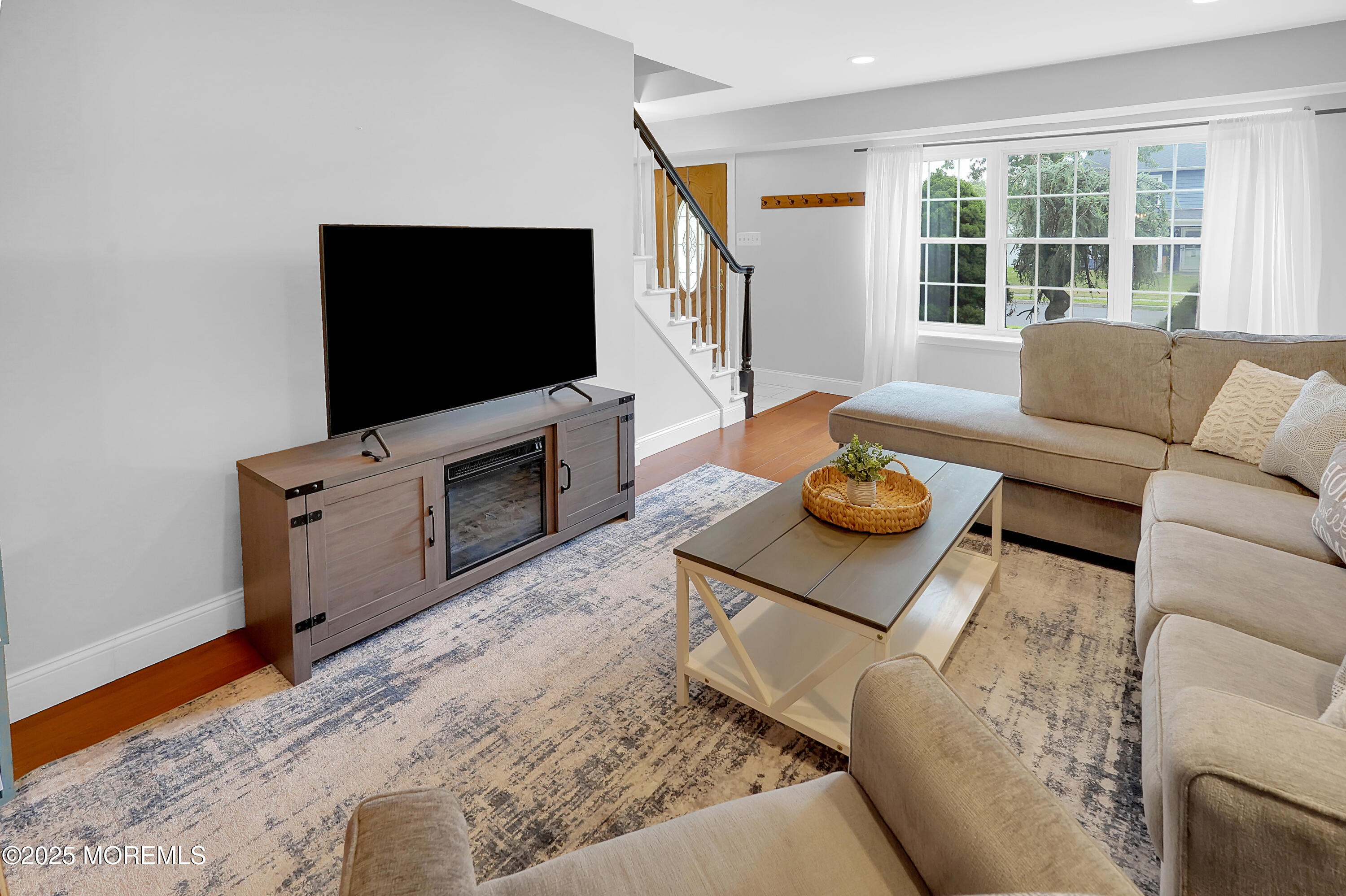 12 Quailtree Lane Howell, NJ 07731 - Photo 9 of 51 a living room with furniture and a flat screen tv