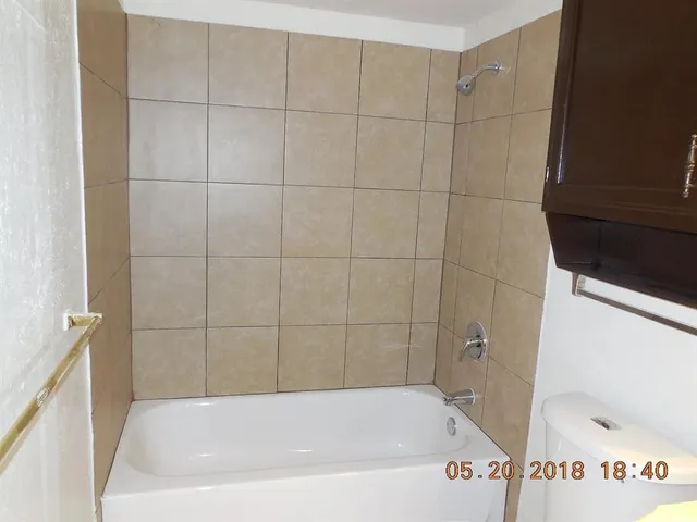 a bath tub sitting next to a white sink and vanity