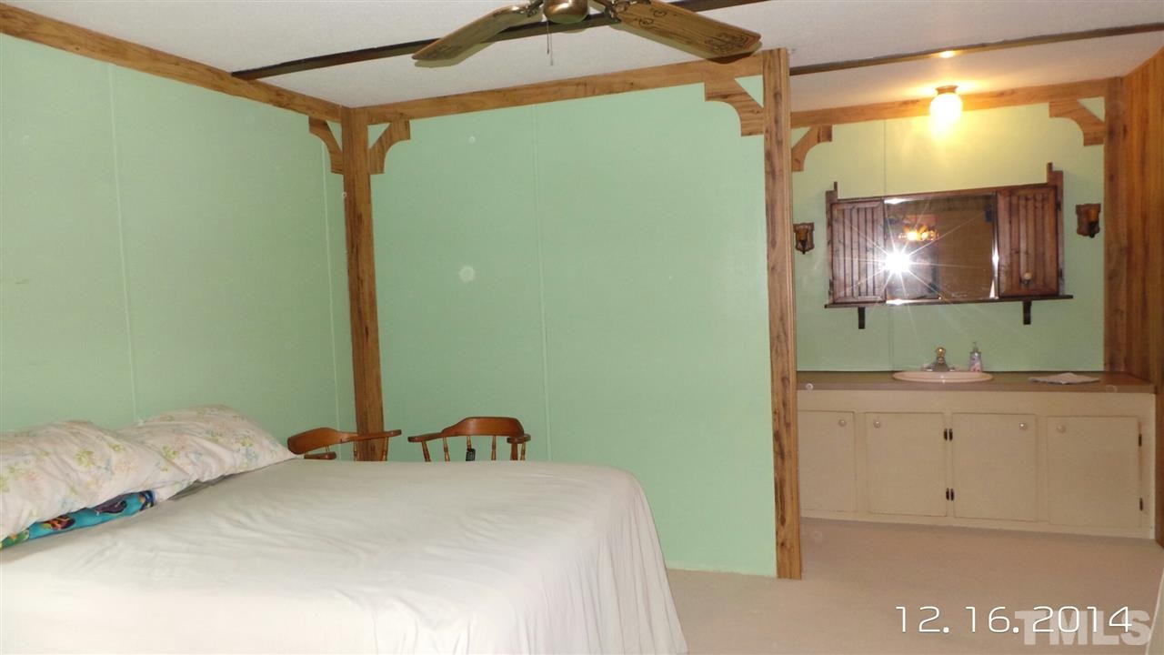 696 Lamms Grove Road Carthage, NC 28327 - Photo 2 of 9 a bedroom with a bed and a flat screen tv