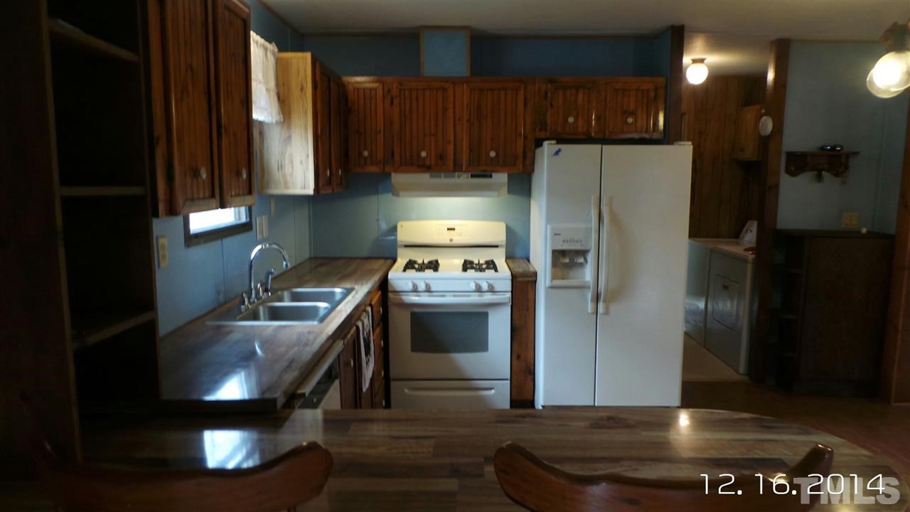 696 Lamms Grove Road Carthage, NC 28327 - Photo 4 of 9 a kitchen with a refrigerator and a sink