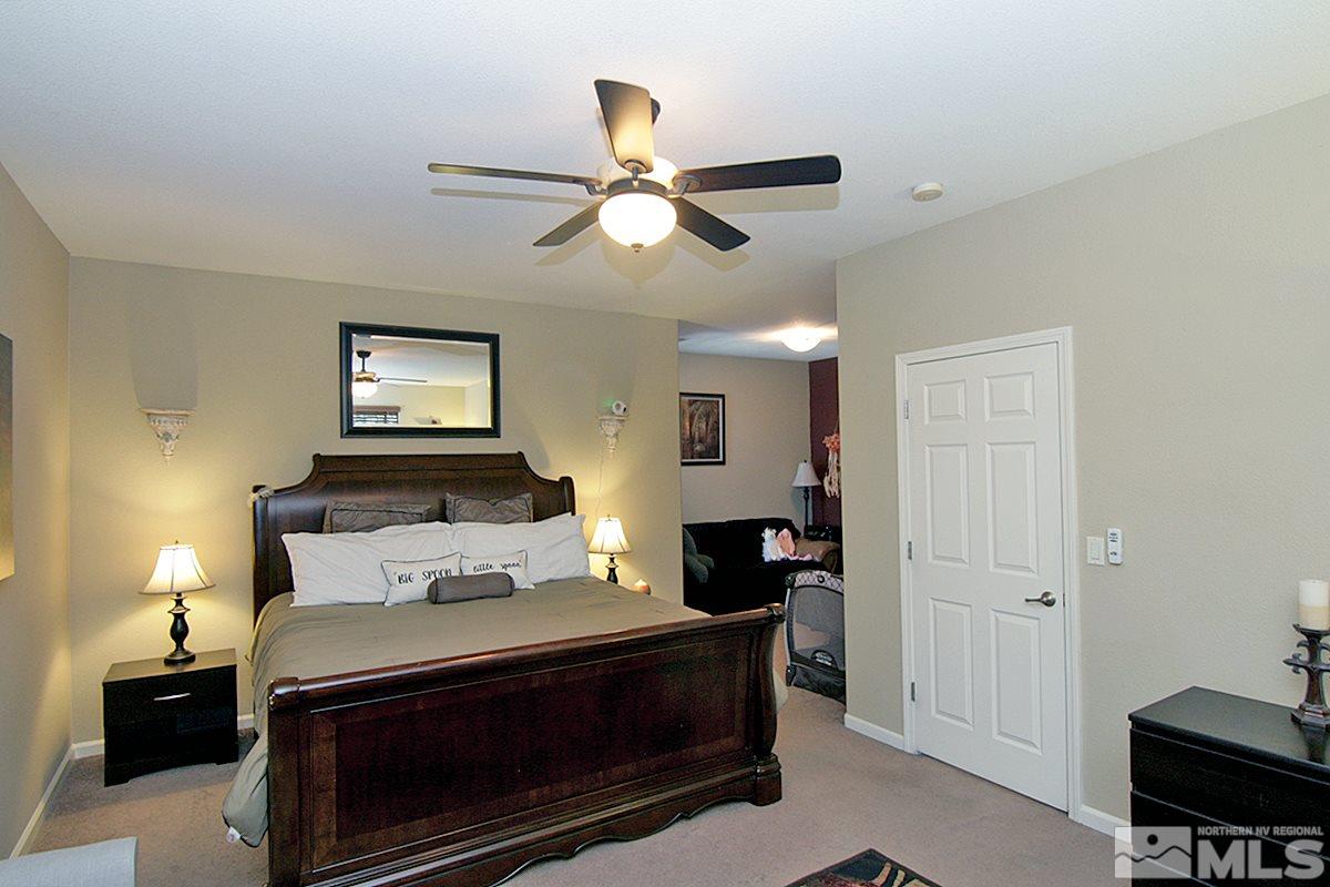 11032 Colton Drive Reno, NV 89521 - Photo 11 of 24 a bedroom with a bed and a lamp on the dresser
