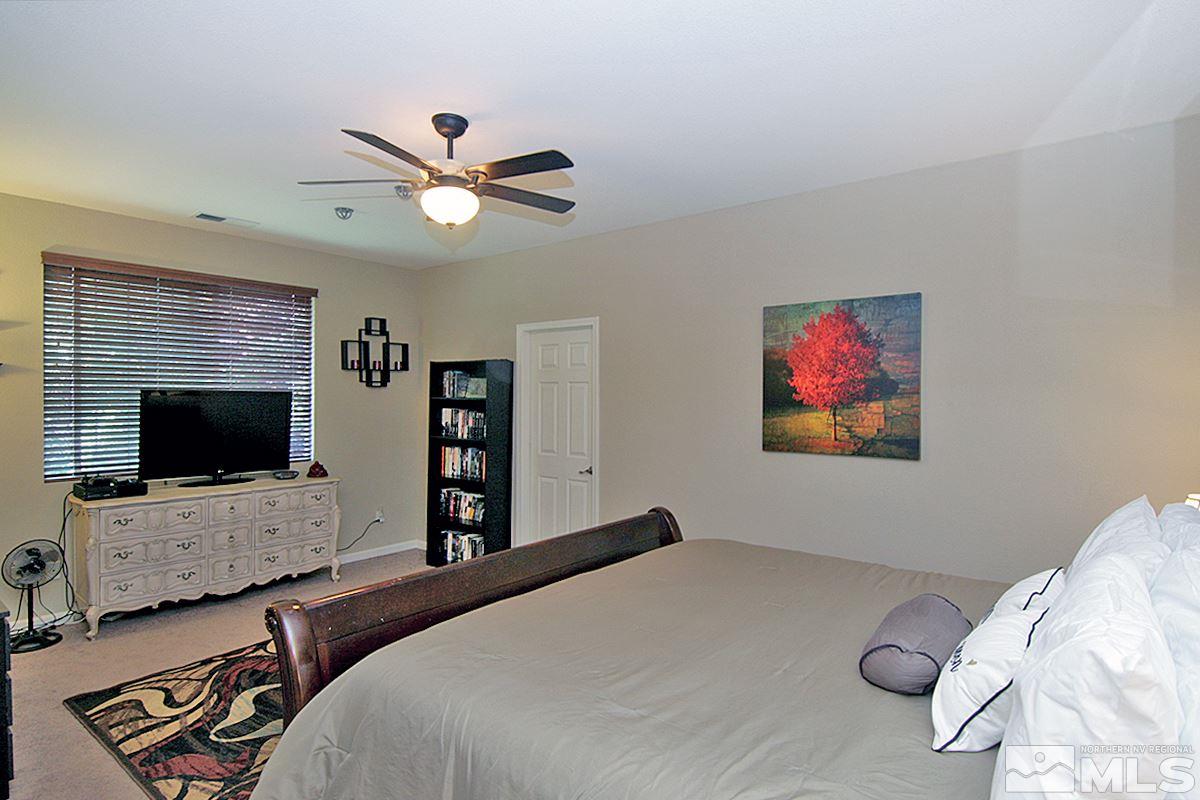 11032 Colton Drive Reno, NV 89521 - Photo 12 of 24 a bedroom with a bed and a flat screen tv
