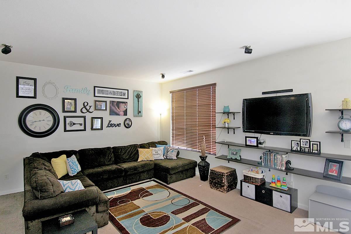 11032 Colton Drive Reno, NV 89521 - Photo 3 of 24 a living room with furniture and a flat screen tv