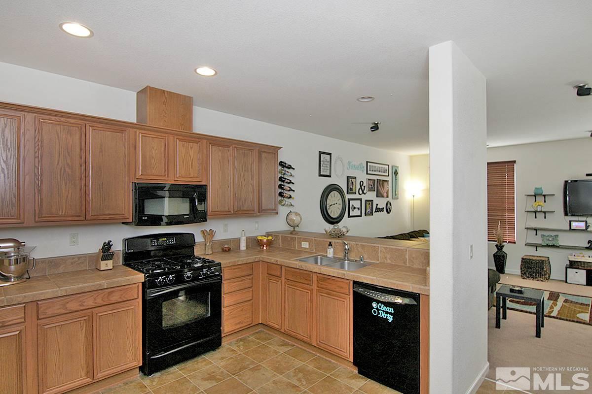 11032 Colton Drive Reno, NV 89521 - Photo 8 of 24 a kitchen with a sink a stove and oven