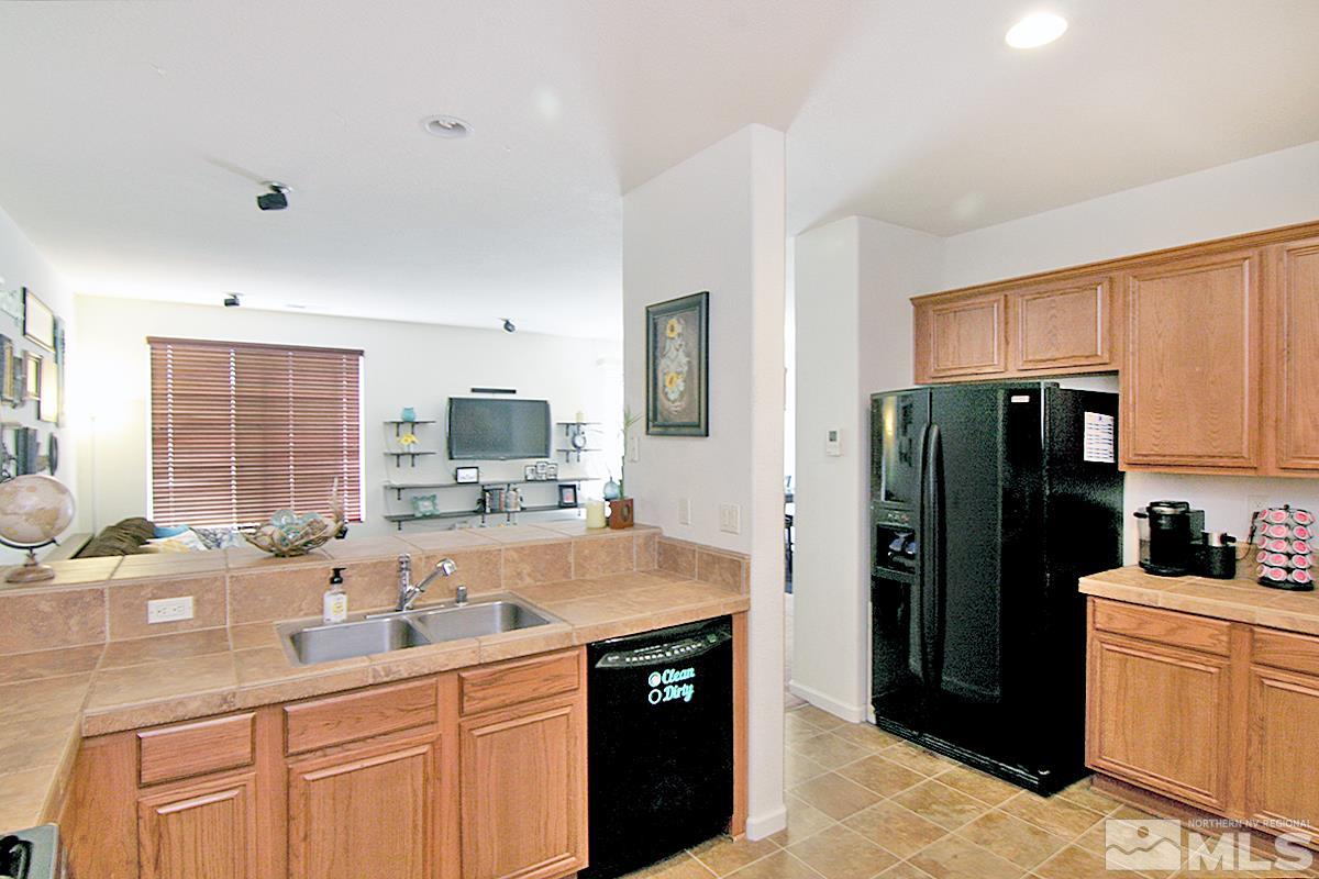 11032 Colton Drive Reno, NV 89521 - Photo 9 of 24 a kitchen with a sink stove and refrigerator
