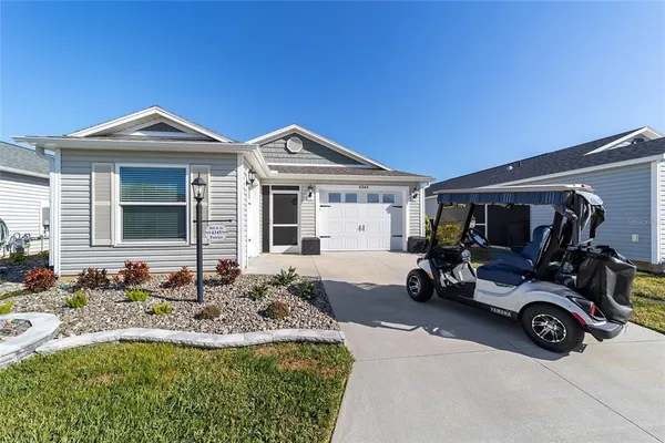 a view of a house with a car parked in front of it