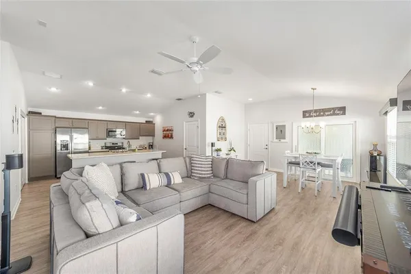a view of living room kitchen with furniture and wooden floor