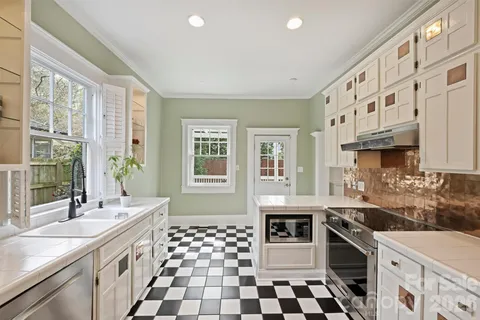a kitchen with stainless steel appliances a sink and a stove