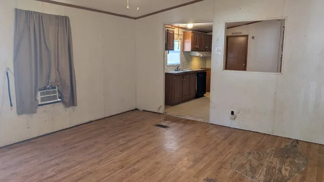 an empty room with mirror and entrance