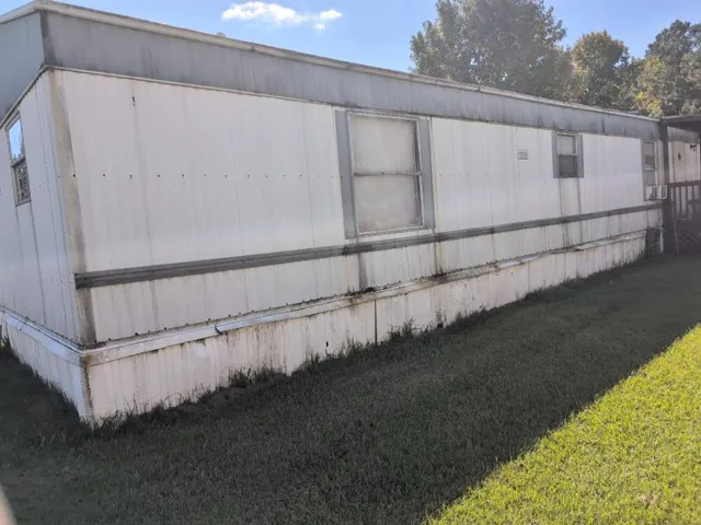 a view of a small house with wooden floor