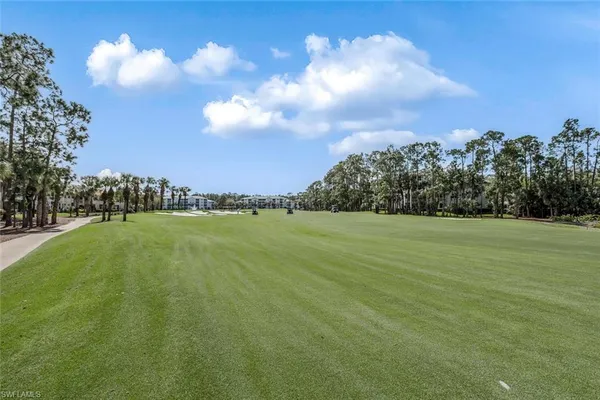 a view of a golf course with lots of green space