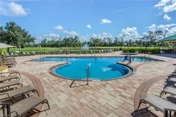 a view of a swimming pool and lounge chairs