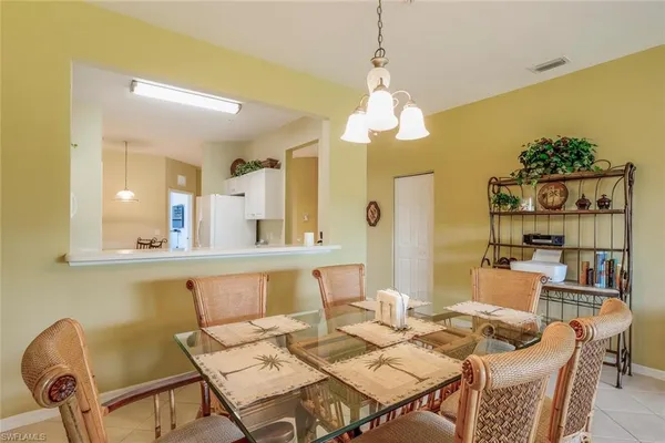 a view of a dining room with furniture and a chandelier