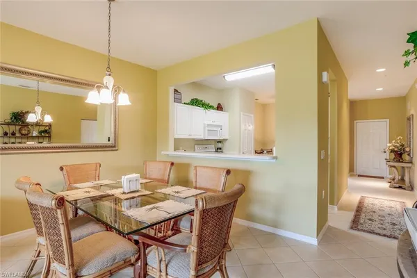 a view of a dining room with furniture and a chandelier