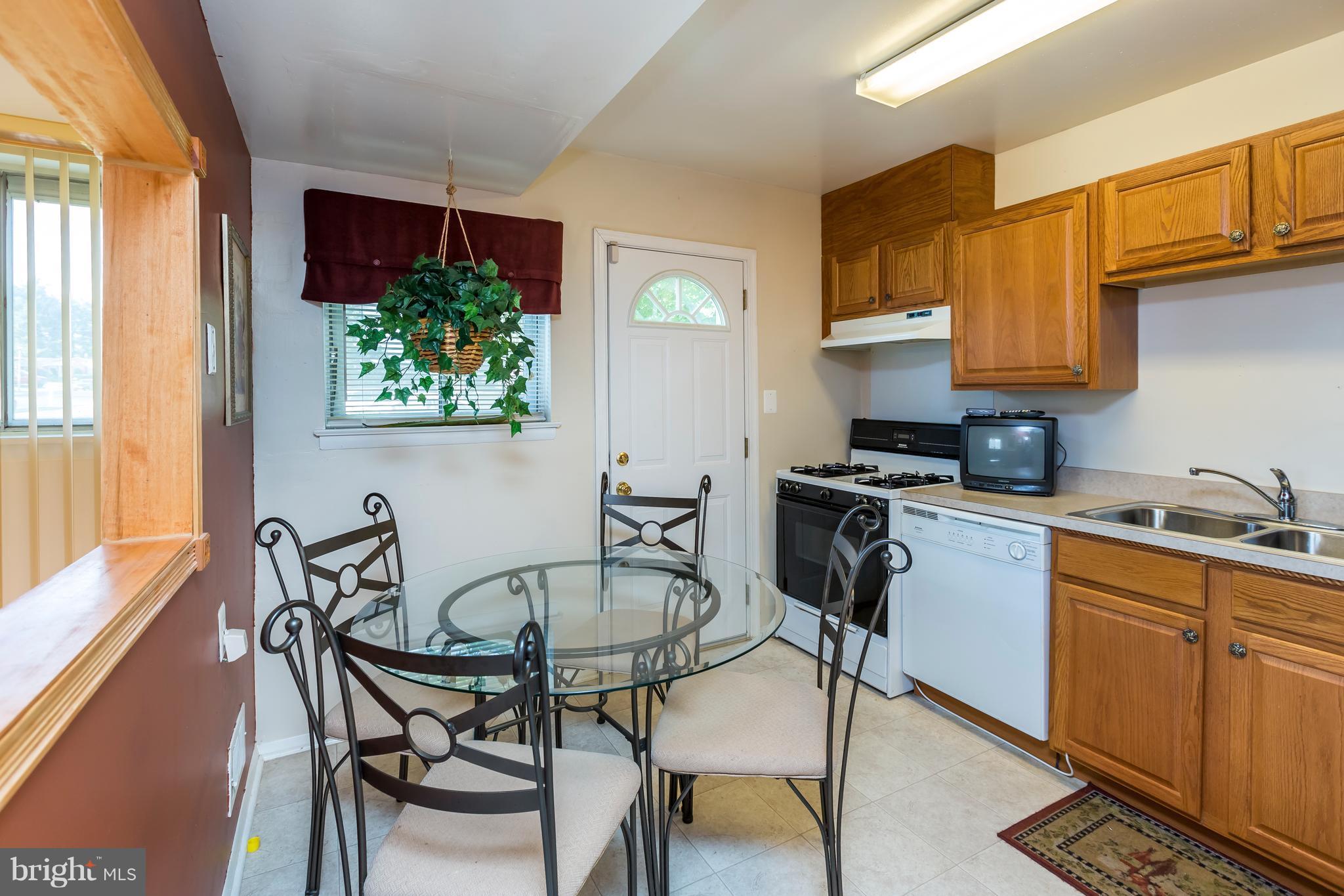 3937 Setonhurst Road Baltimore, MD 21208 - Photo 11 of 29 a kitchen with stainless steel appliances kitchen island granite countertop a sink and cabinets