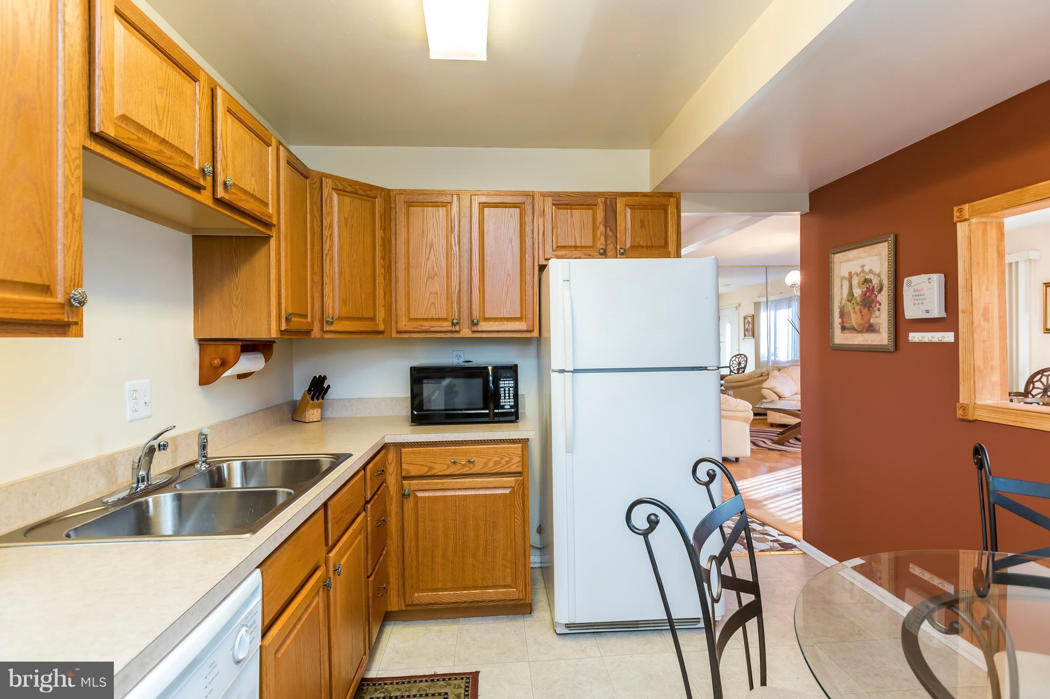 3937 Setonhurst Road Baltimore, MD 21208 - Photo 13 of 29 a kitchen with stainless steel appliances granite countertop a refrigerator and a sink