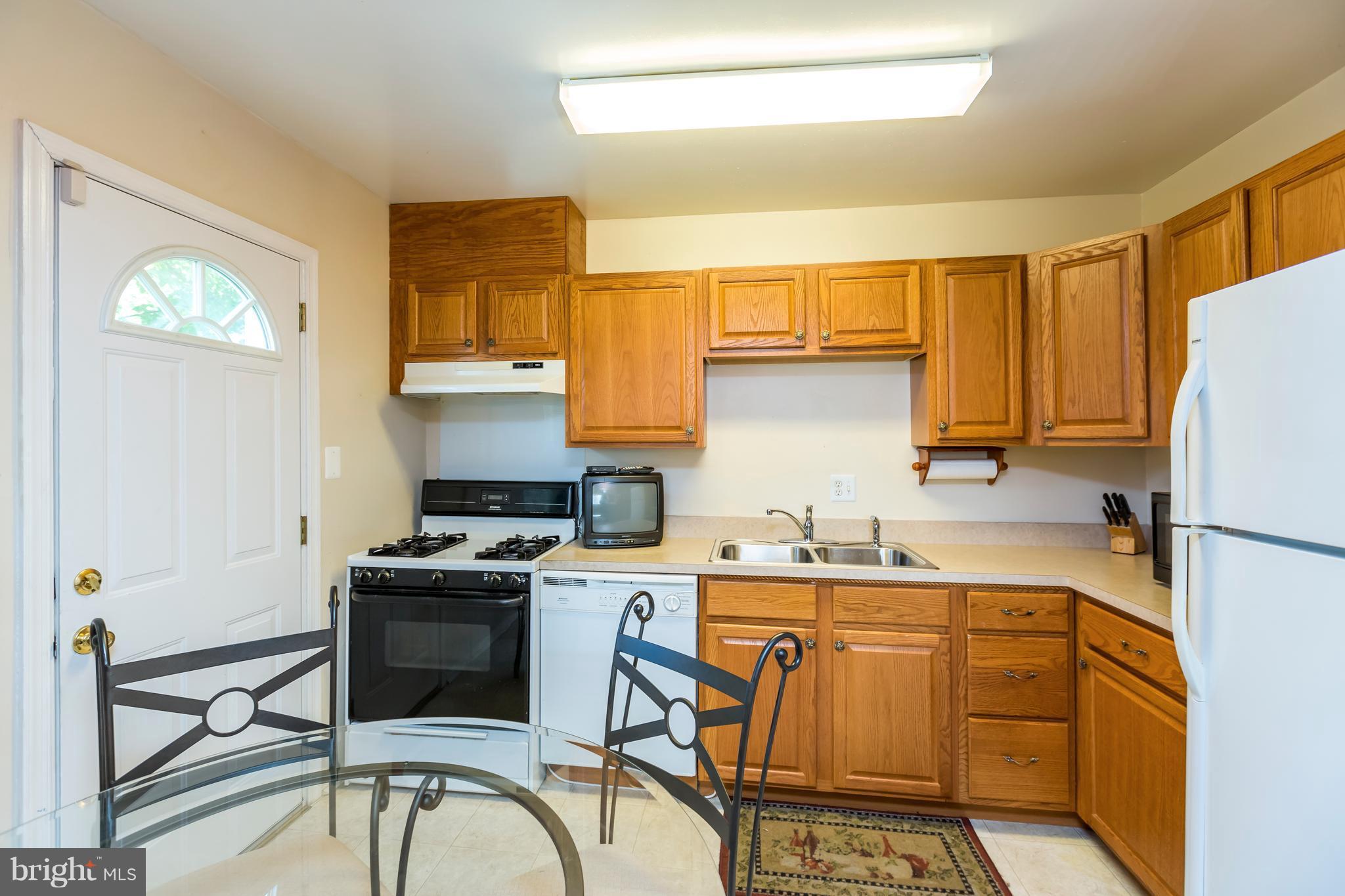 3937 Setonhurst Road Baltimore, MD 21208 - Photo 15 of 29 a kitchen with a sink a stove and refrigerator