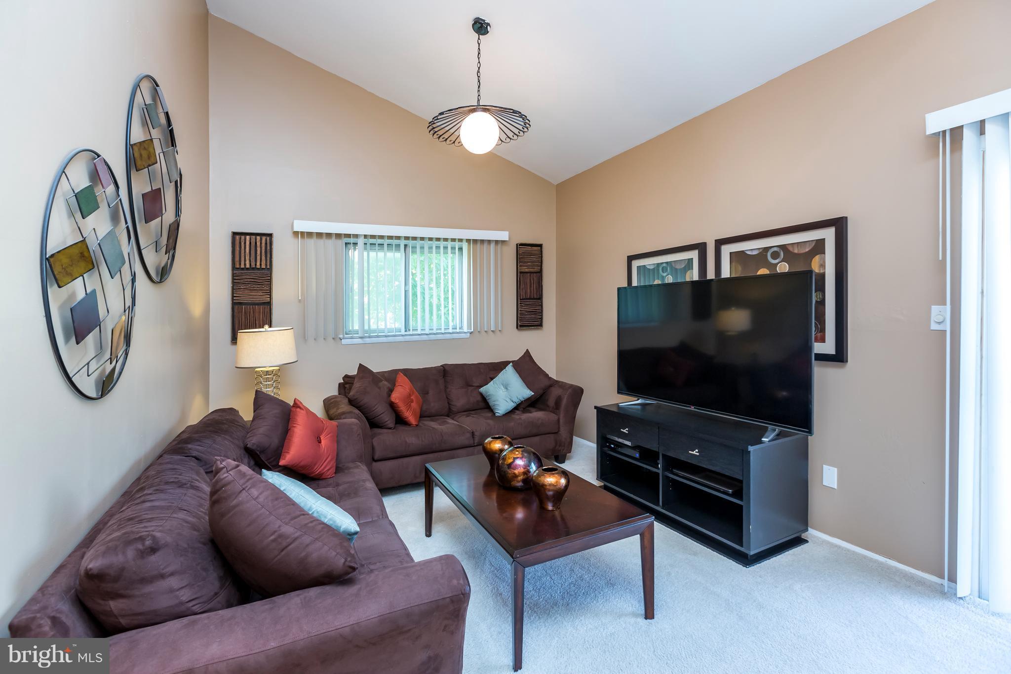 3937 Setonhurst Road Baltimore, MD 21208 - Photo 16 of 29 a living room with furniture and a flat screen tv