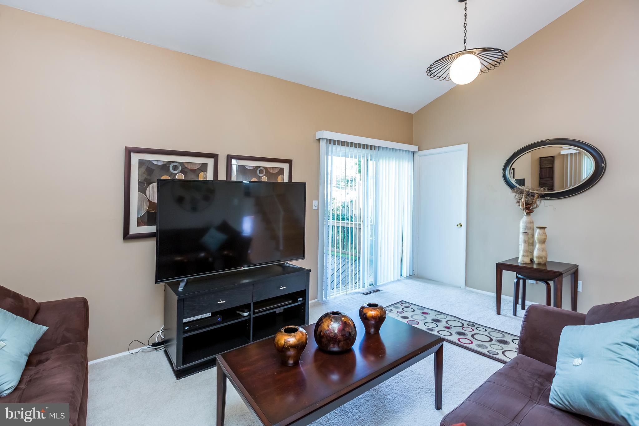 3937 Setonhurst Road Baltimore, MD 21208 - Photo 18 of 29 a living room with furniture and a flat screen tv