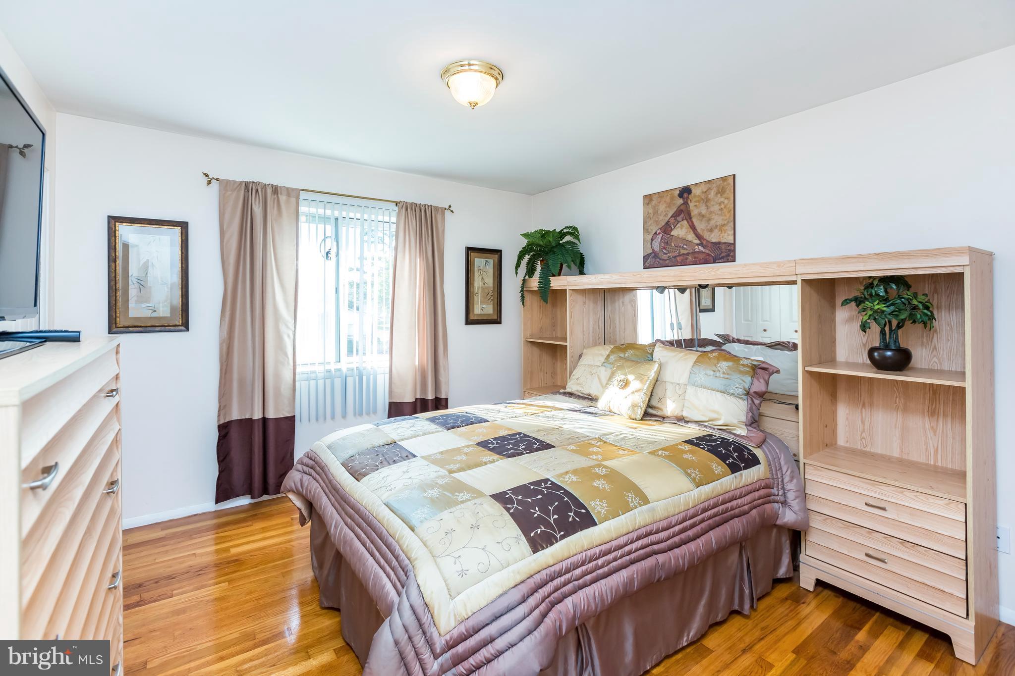 3937 Setonhurst Road Baltimore, MD 21208 - Photo 23 of 29 a bedroom with a bed and a window