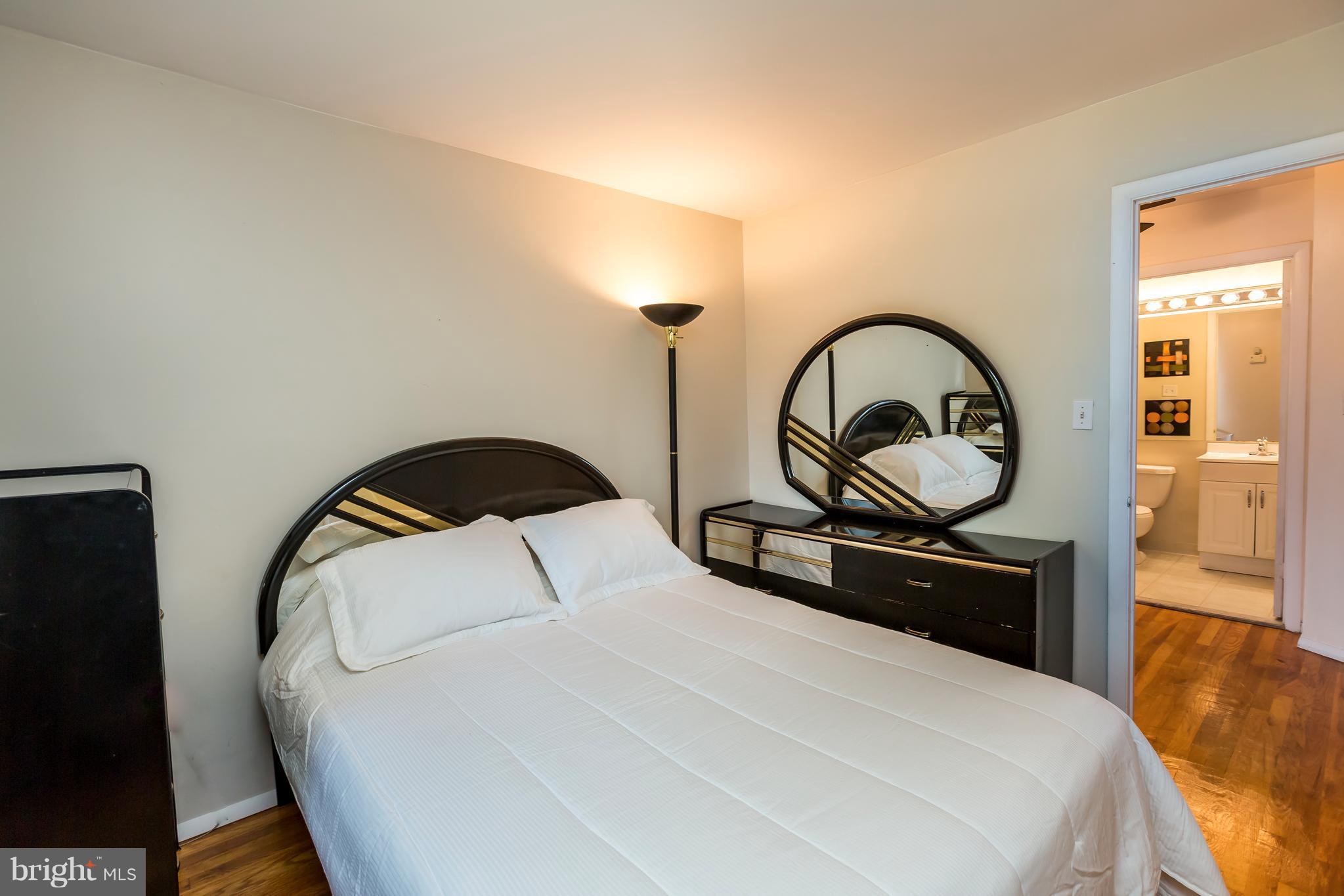 3937 Setonhurst Road Baltimore, MD 21208 - Photo 26 of 29 a bedroom with a bed and a black countertop