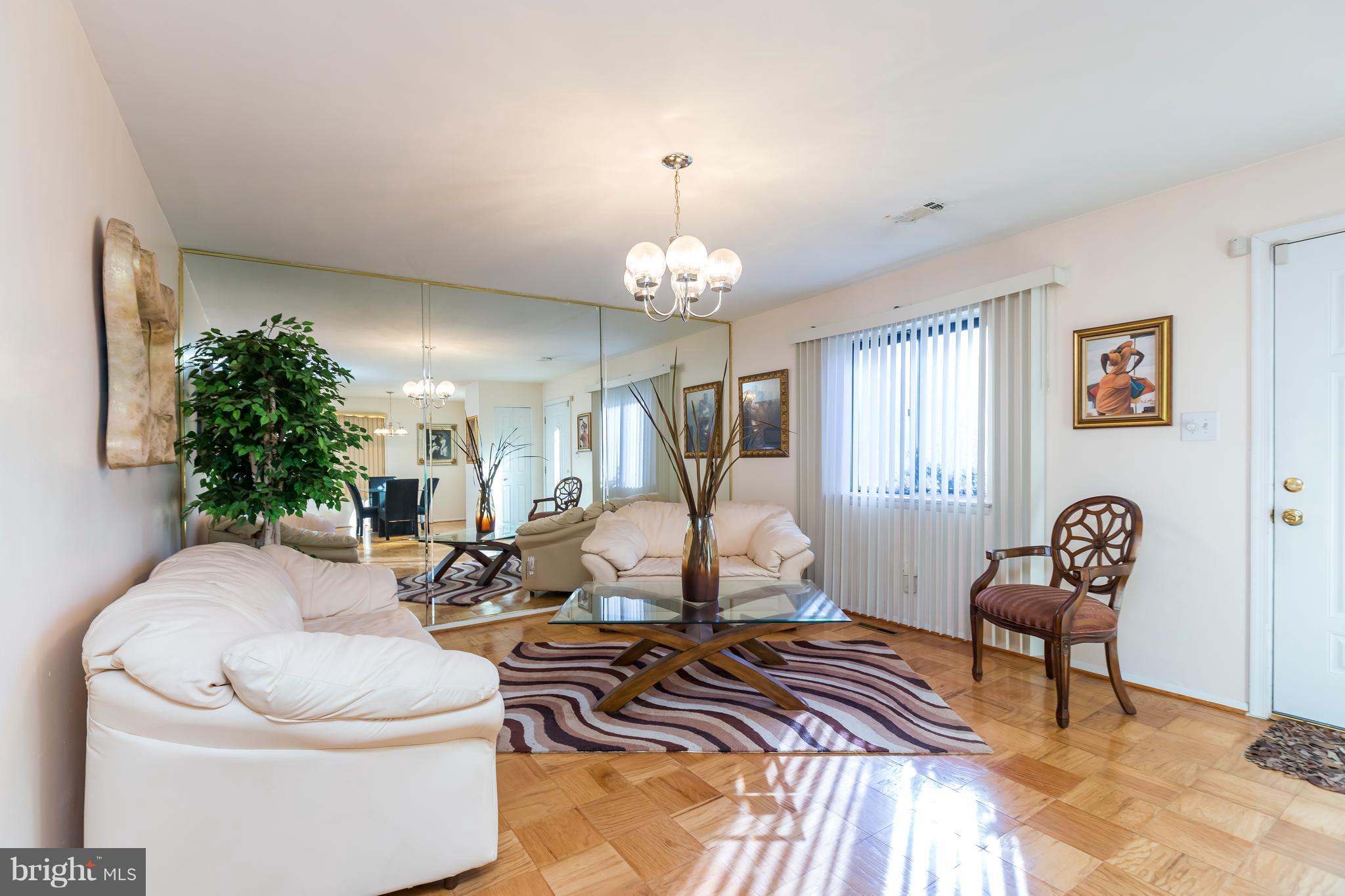 3937 Setonhurst Road Baltimore, MD 21208 - Photo 4 of 29 a living room with furniture and a chandelier