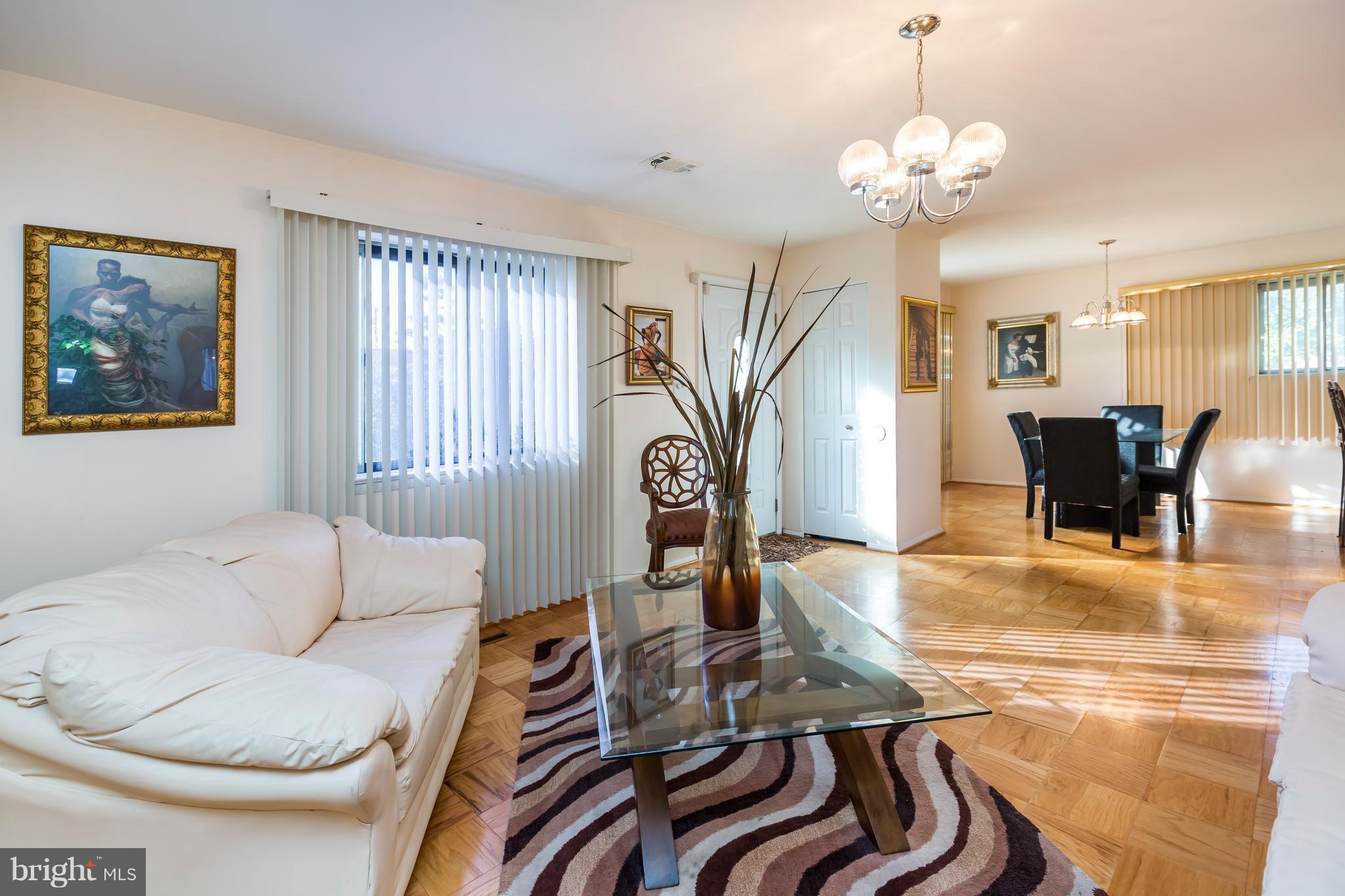 3937 Setonhurst Road Baltimore, MD 21208 - Photo 6 of 29 a living room with furniture and a chandelier
