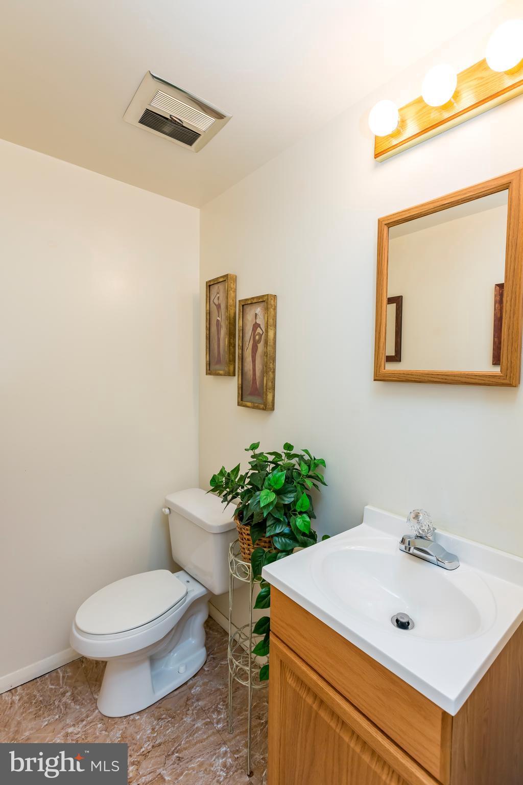 3937 Setonhurst Road Baltimore, MD 21208 - Photo 10 of 29 a bathroom with a sink mirror and toilet