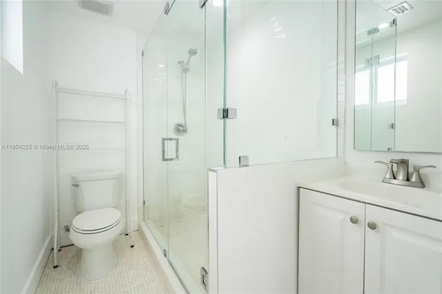 a bathroom with a toilet a sink and shower