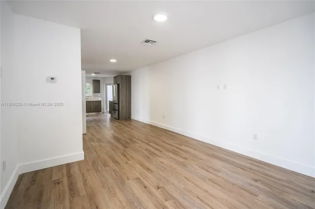 a view of hallway with wooden floor