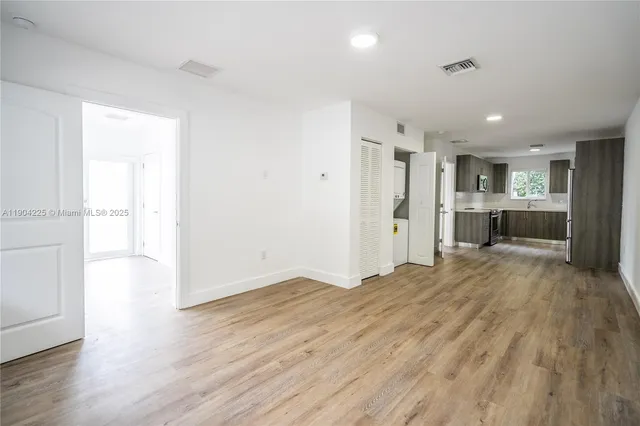 a view of a kitchen with a sink and a refrigerator