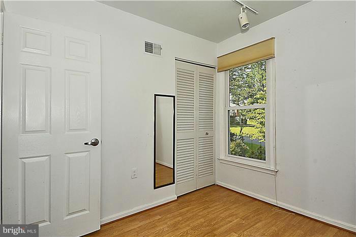 6716 Garrett Road Derwood, MD 20855 - Photo 17 of 30 an empty room with wooden floor and windows