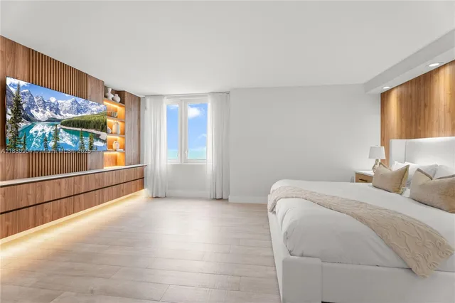 a bed room with a bed and a large window