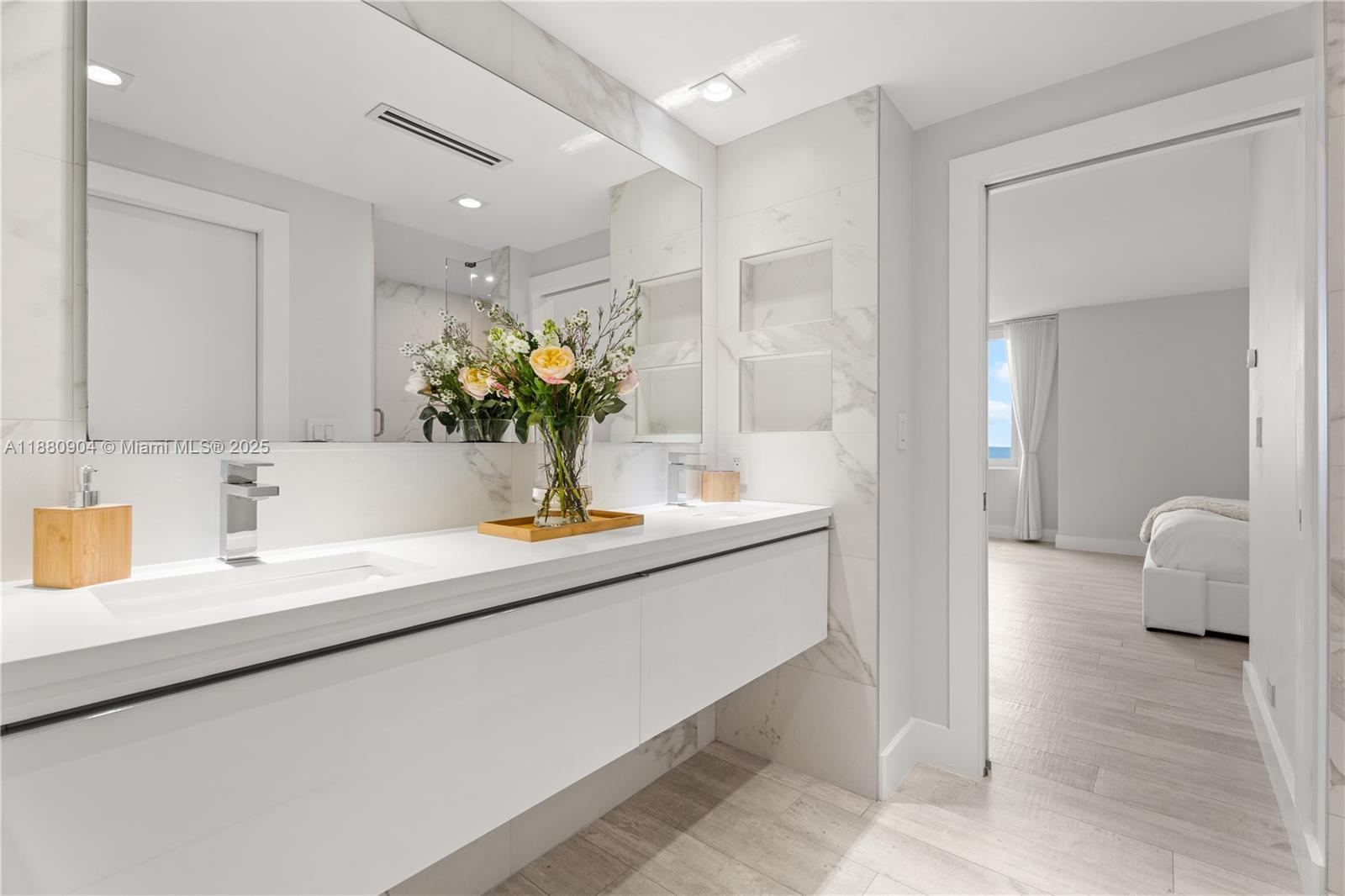 2301 Collins Avenue, Unit 152324 Miami Beach, FL 33139 - Photo 14 of 26 a bathroom with a sink and a mirror