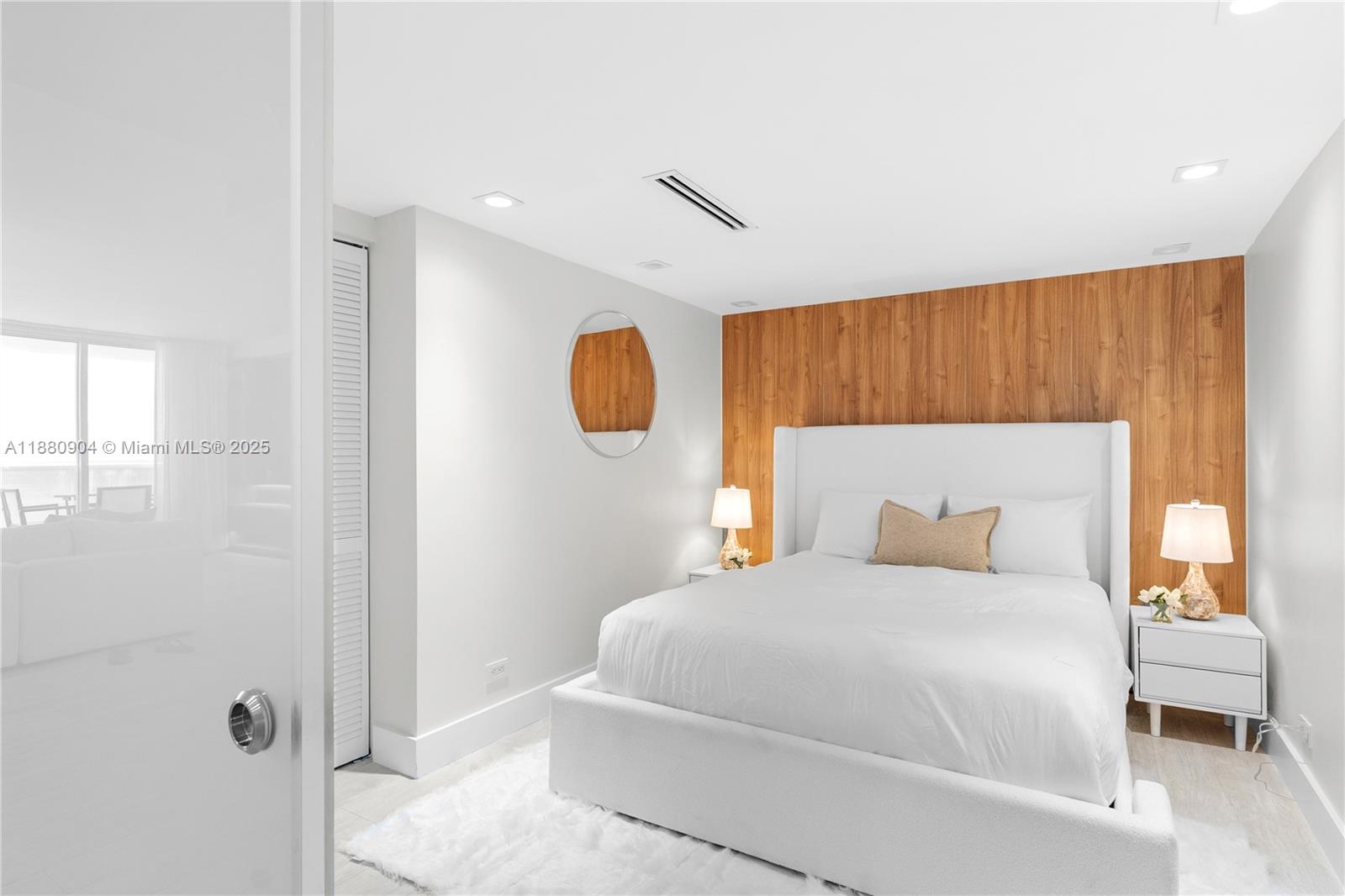 2301 Collins Avenue, Unit 152324 Miami Beach, FL 33139 - Photo 17 of 26 a bedroom with a bed and a potted plant