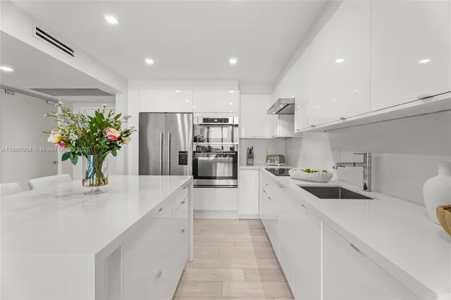 a kitchen with a potted plant on the counter and cabinets