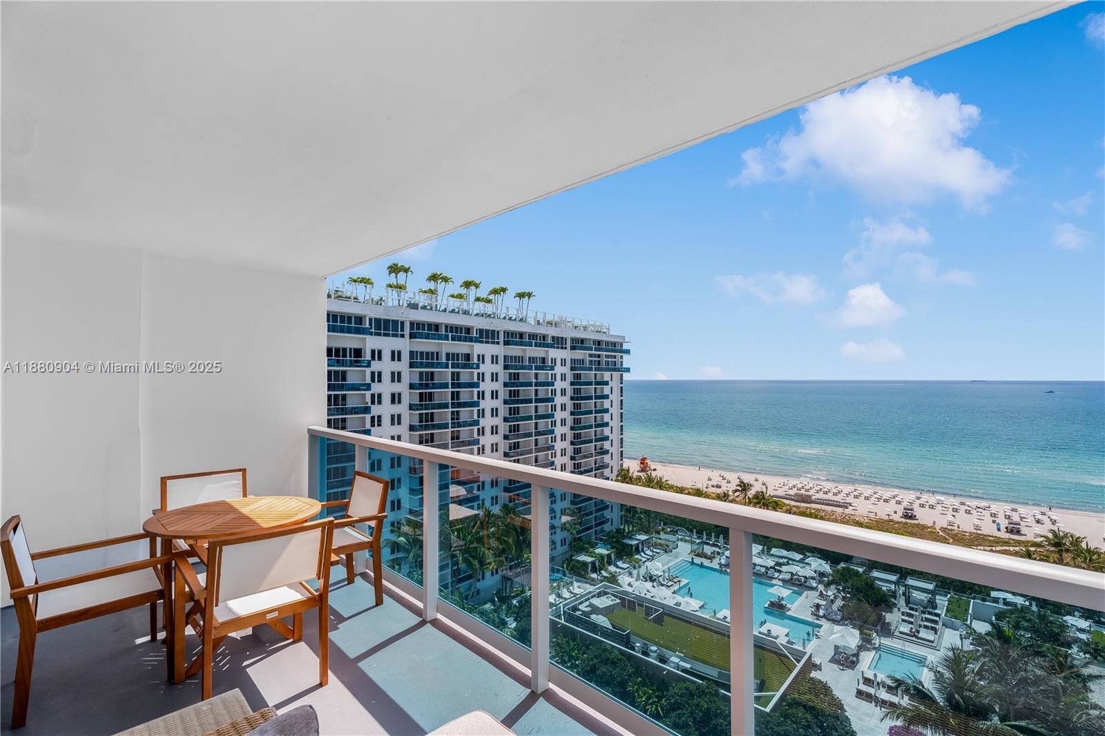 2301 Collins Avenue, Unit 152324 Miami Beach, FL 33139 - Photo 22 of 26 a roof deck with a table and chairs and wooden floor
