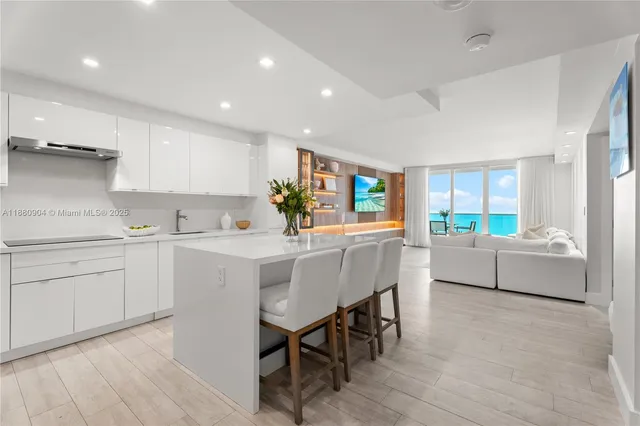 a kitchen with stainless steel appliances kitchen island granite countertop a stove a sink a dining table and chairs