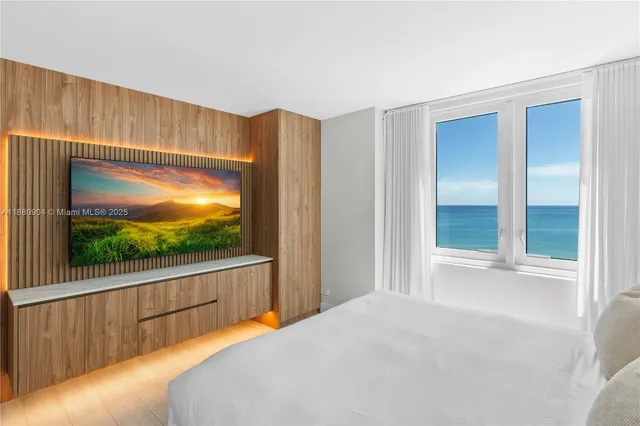 a bedroom with a bed and a large window