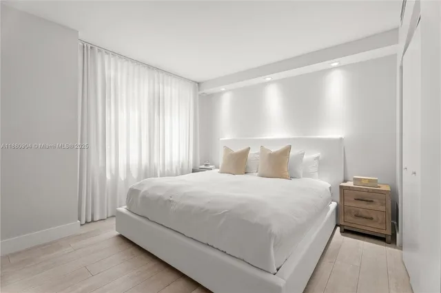 a bedroom with a bed and a night stand