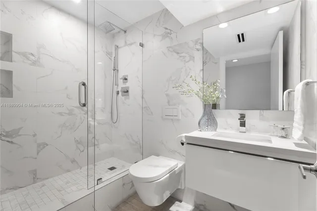 a bathroom with a sink toilet and shower