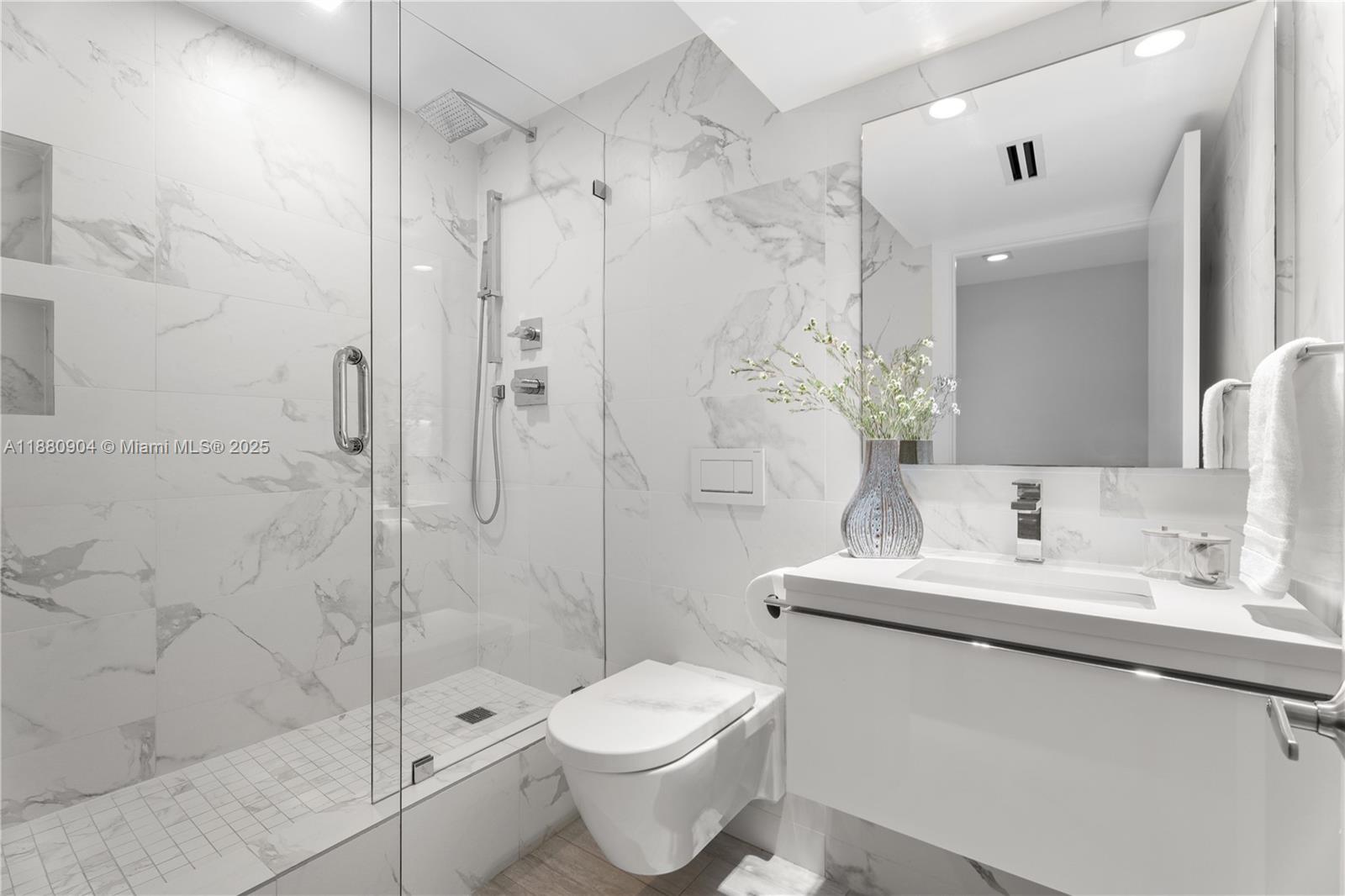 2301 Collins Avenue, Unit 152324 Miami Beach, FL 33139 - Photo 8 of 26 a bathroom with a sink toilet and shower