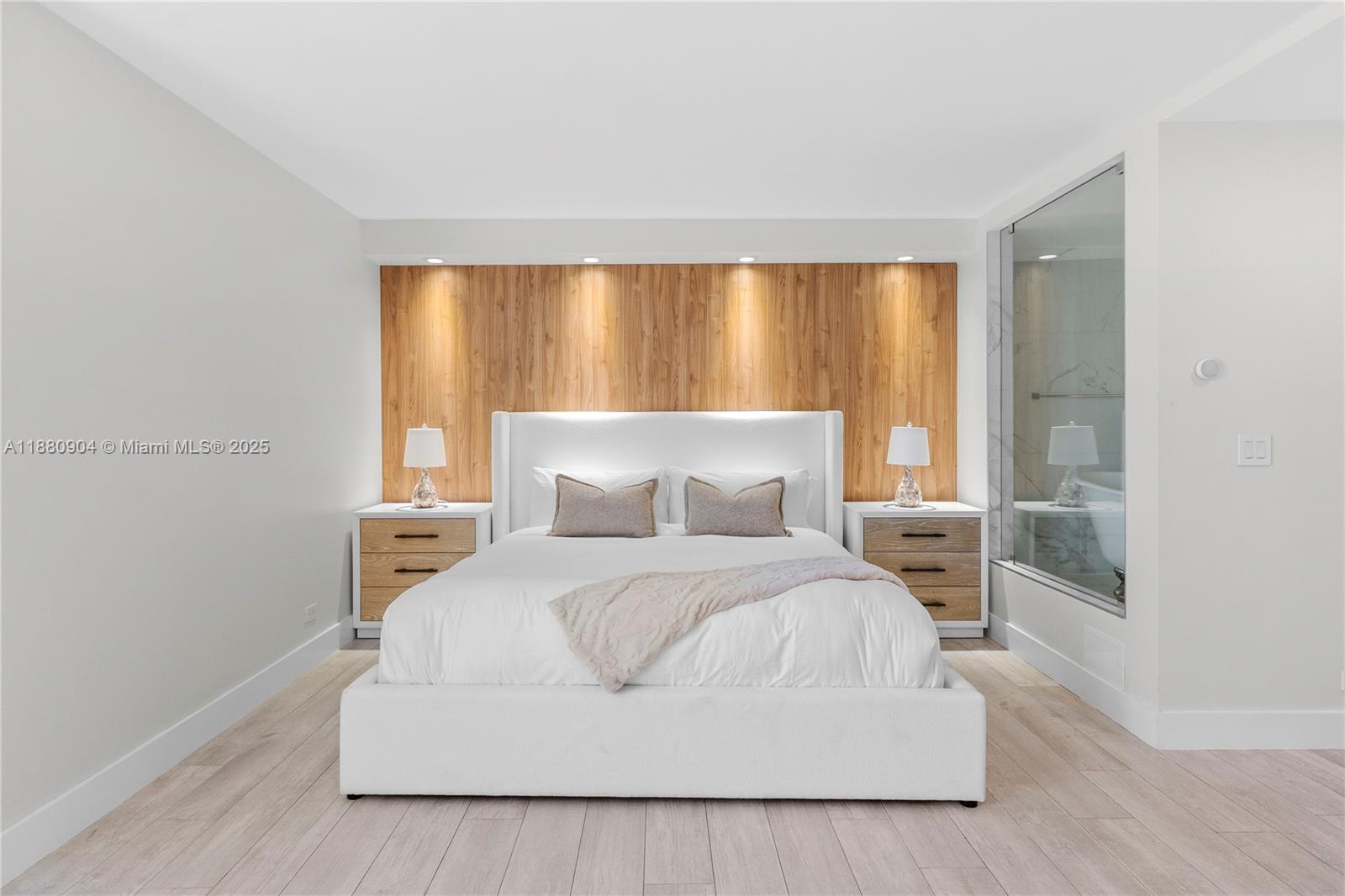 2301 Collins Avenue, Unit 152324 Miami Beach, FL 33139 - Photo 9 of 26 a bedroom with a white bed and a large window