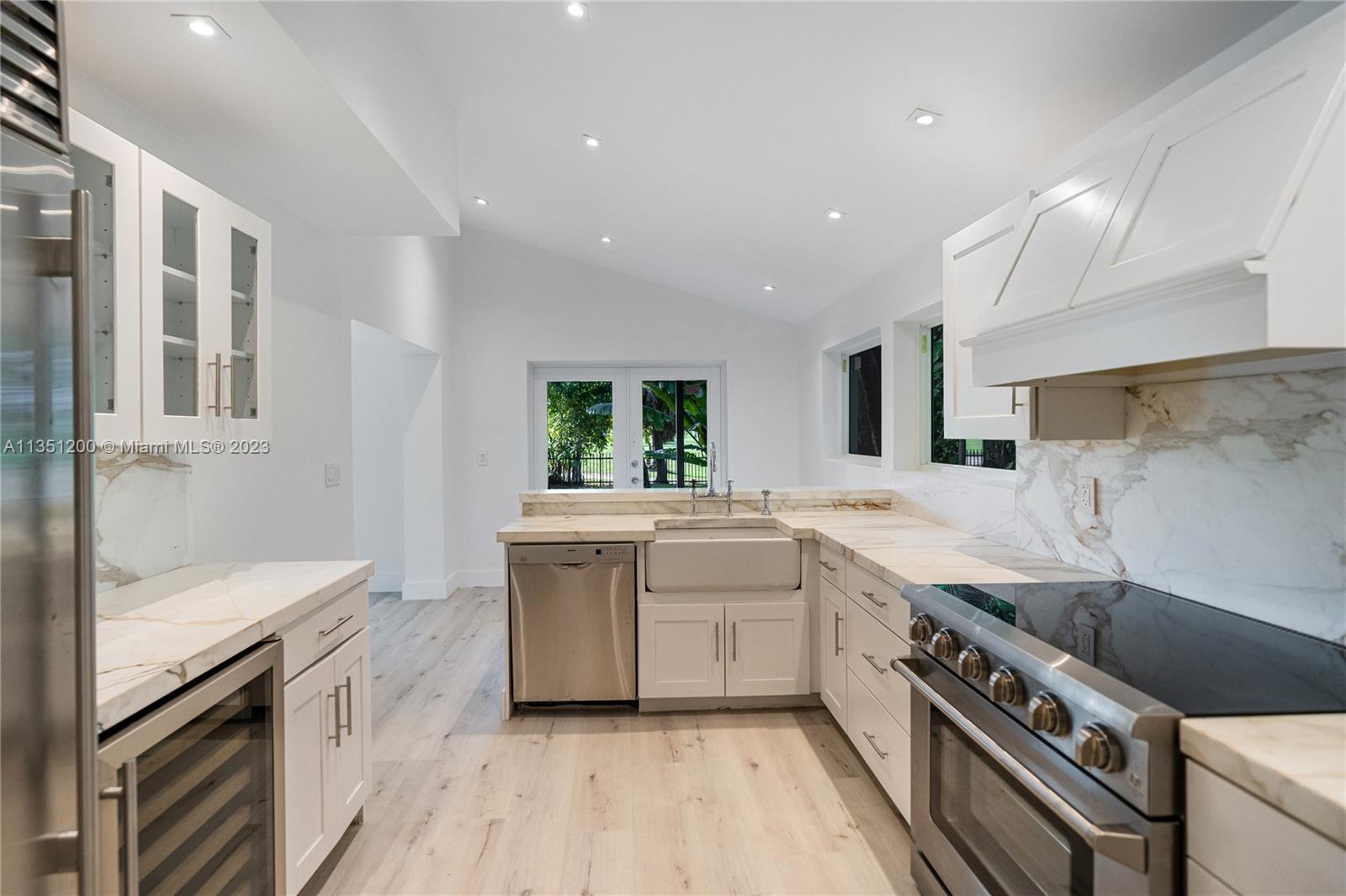5512 La Gorce Drive Miami Beach, FL 33140 - Photo 16 of 35 a kitchen with a sink stove and cabinets