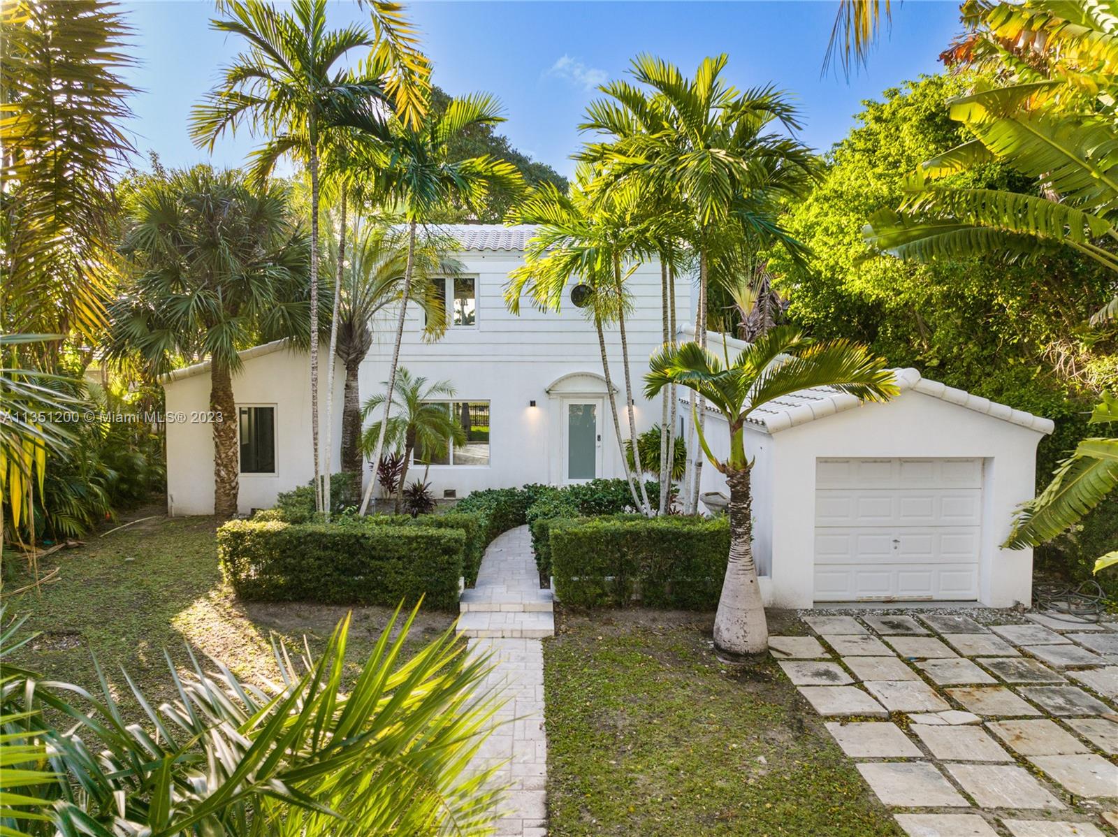 5512 La Gorce Drive Miami Beach, FL 33140 - Photo 2 of 35 a front view of a house with a garden