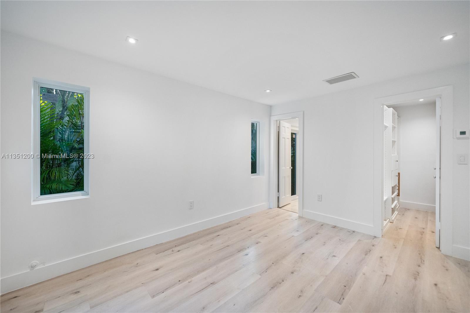5512 La Gorce Drive Miami Beach, FL 33140 - Photo 25 of 35 a view of an empty room with wooden floor and a window