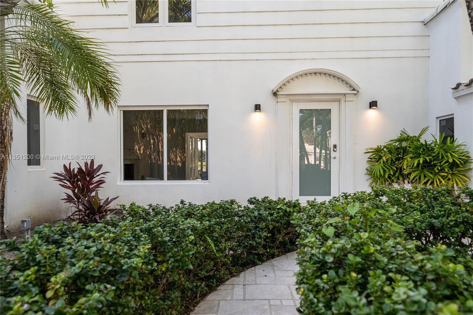 5512 La Gorce Drive Miami Beach, FL 33140 - Photo 5 of 35 a front view of a house with a garden